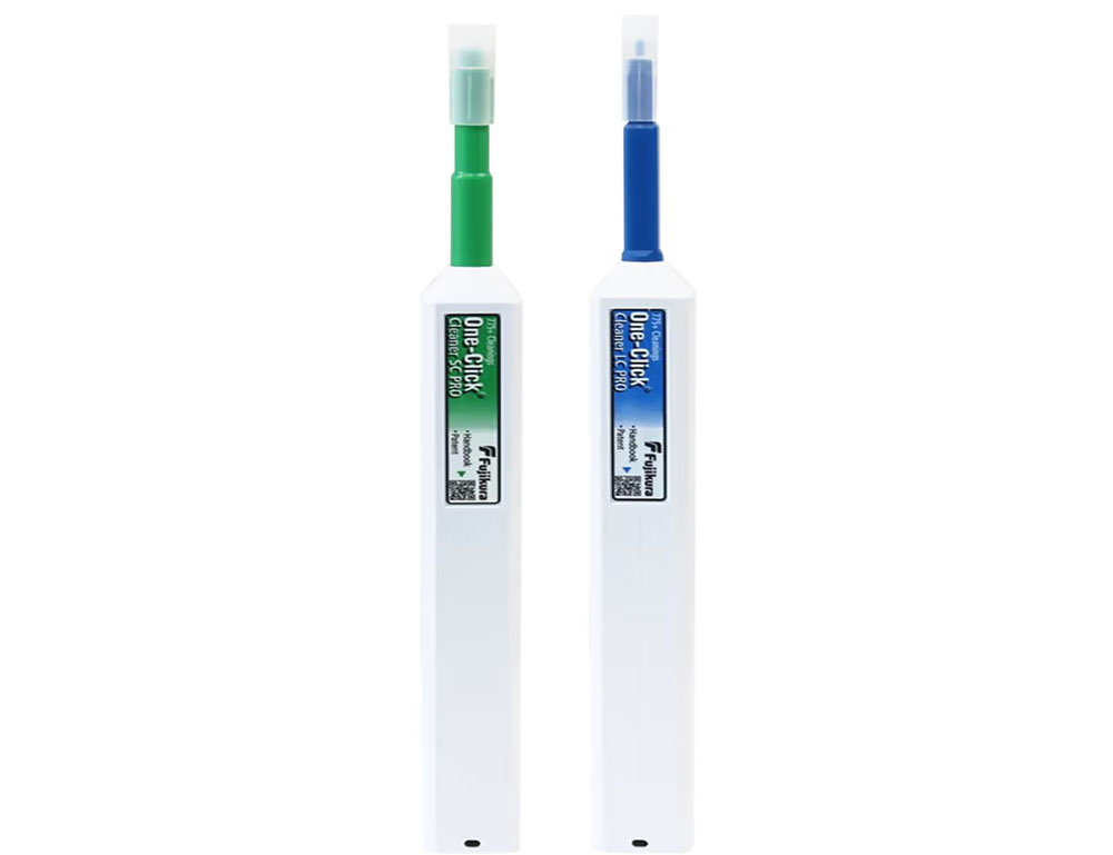 Two fiber optic cleaning tools with white bodies, one with a green tip and one with a blue tip, shown upright.